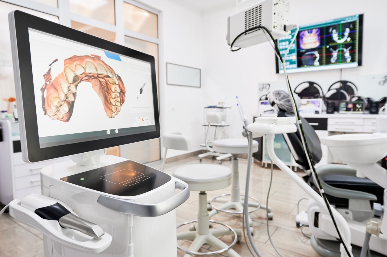 Interior of dental office with modern equipment and dental intraoral scanner with teeth on display, medical system for intraoral scanning. Concept of digital dentistry and dental scanning technology. - Dental intraoral scanner in modern clinic. - 1281462708