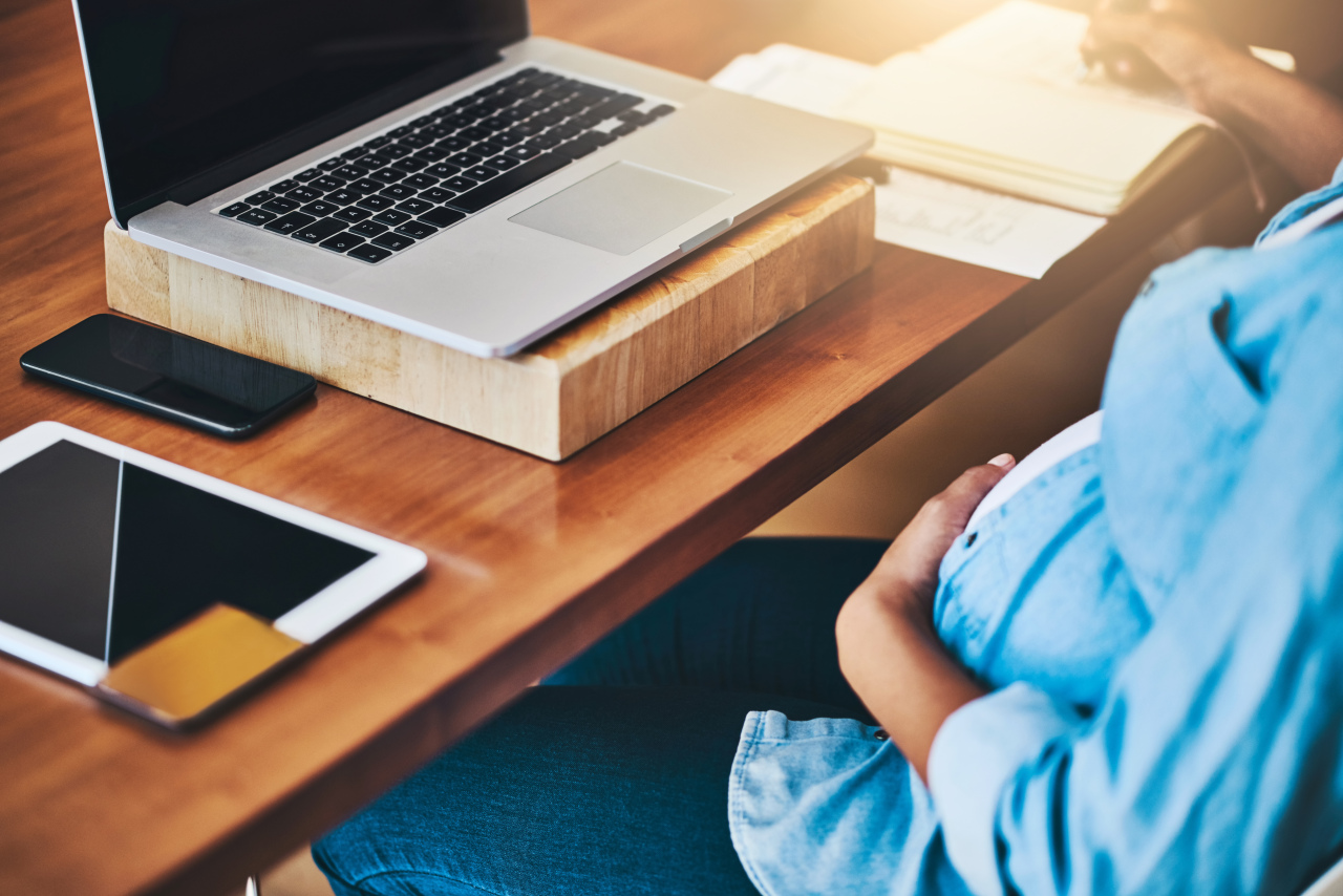 Cropped shot of a pregnant woman using a laptop while working from home - Tending to business before baby arrives - 958841976